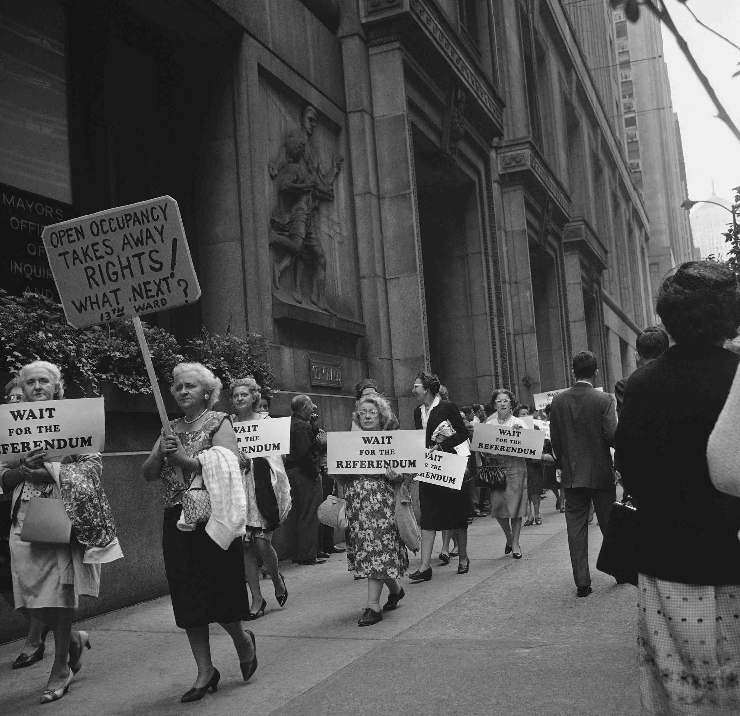 Demonstrators marching around Chicago's City Hall carry signs protesting an ordinance banning discrimination in real estate deals, Sept. 11, 1963 (Associated Press)
