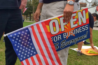 Protest sign and american flag