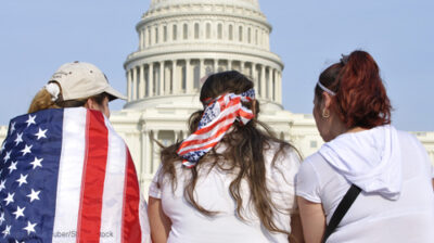 American women sitting in front of the capitol building