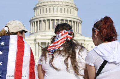American women sitting in front of the capitol building