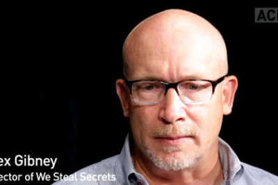 A man seen from the neck up with glasses.