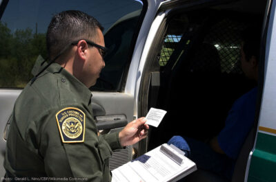 Border Patrol agent reads the Miranda rights to a Mexican national arrested for transporting drugs
