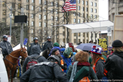 Seattle police on horseback watch protesters.