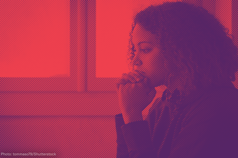 Woman with hands clasped in front of her