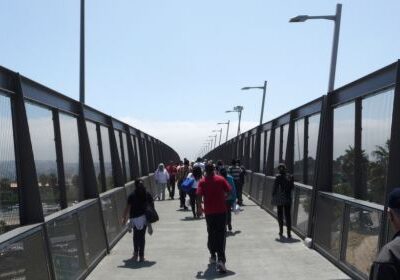 People walking over a bridge.