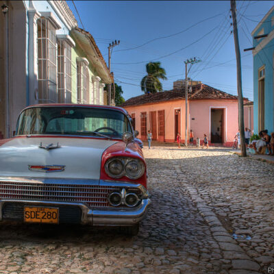 Photo of vintage car parked on Cuban street