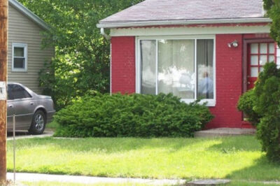 Red house with a green lawn