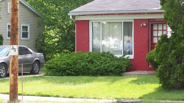 Red house with a green lawn