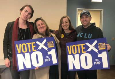 From left: Lillian Lennon (Transgender Community Organizer, ACLU of Alaska); Liz Welch (ACLU); Kati Ward (Fair Anchorage Campaign Manager); Joshua Decker (Executive Director, ACLU of Alaska). All holding "Vote no on prop 1 signs."