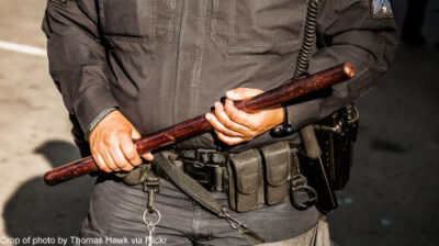 Photo of police officer holding nightstick