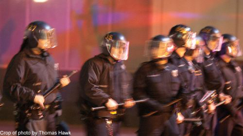 Photo of police standing with batons