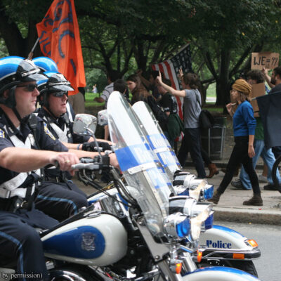 Police on motorcycles in front of protesters
