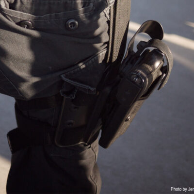 Closeup of gun on police officer's hip