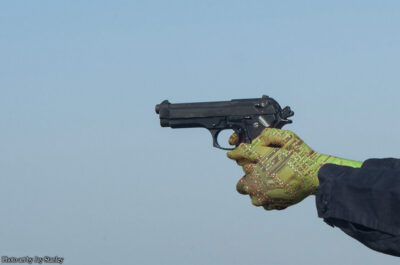 Robot hands holding a pointed handgun