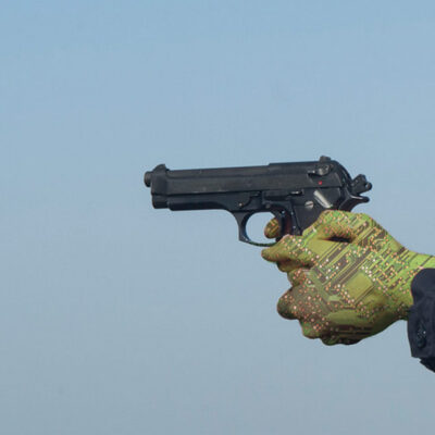 Robot hands holding a pointed handgun