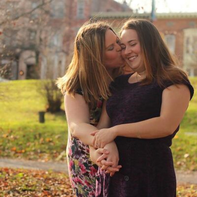 Kissing couple holding hands