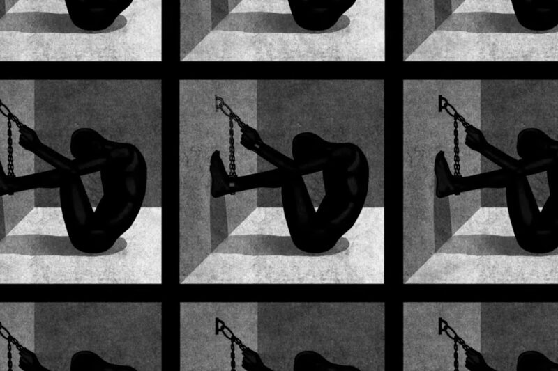 silouette of man chained to wall in solitary