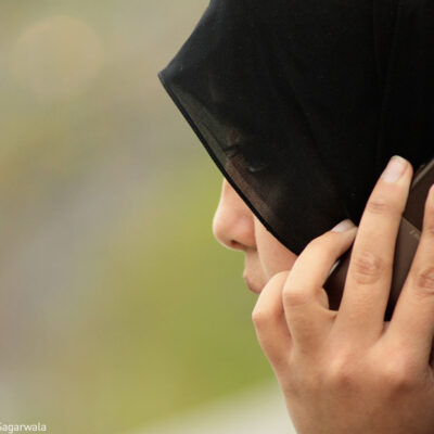 Woman wearing hijab on phone