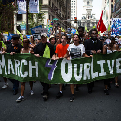 Crown marching with #March 4 Our Lives sign
