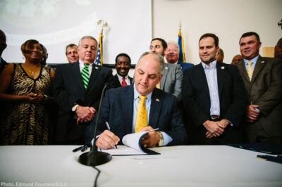Gov. Edwards signs historic justice reinvestment legislation in a room full of advocates.