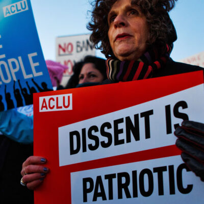 Protester holding "Dissent is Patriotic" Sign