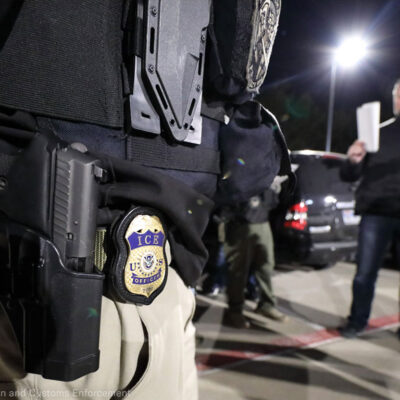 ICE agent with paper