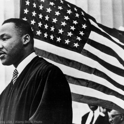 MLK in front of American flag
