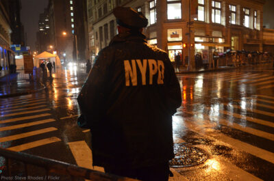 NYPD Officer standing at corner at night
