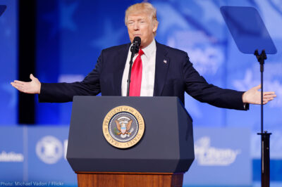 President Trump at Podium With Arms Spread