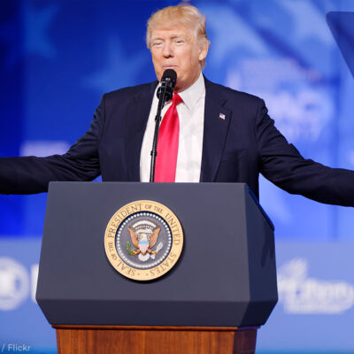 President Trump at Podium With Arms Spread