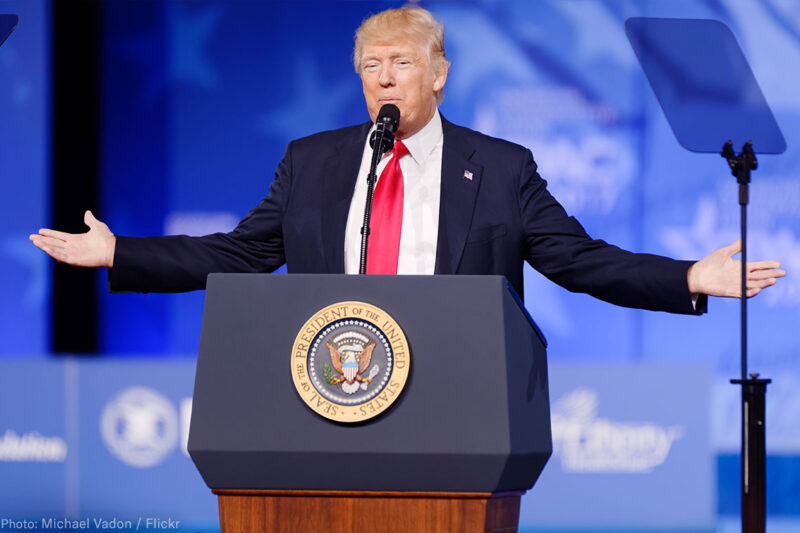 President Trump at Podium With Arms Spread