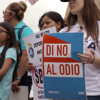 Protesters holding "No SB4" signs