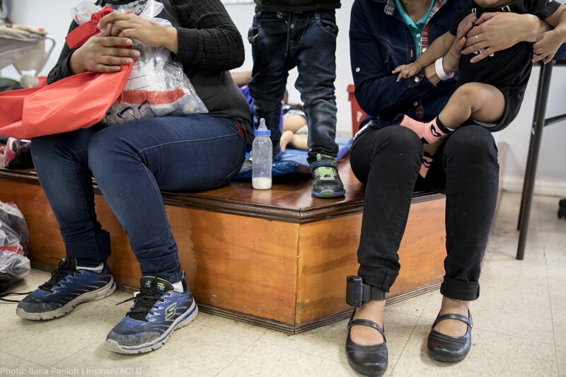 Immigrant women and children at a holding center with ankle monitors