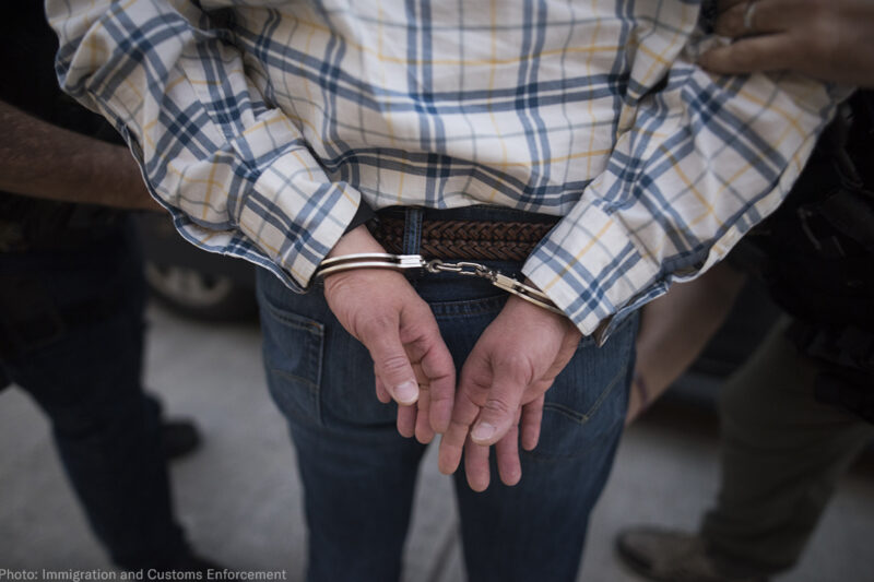 A man handcuffed from behind