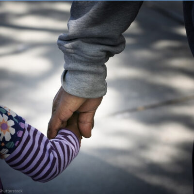 Father holding daughter's hand