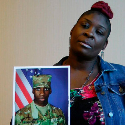 April Pipkins hold a picture of her son, EJ Bradford