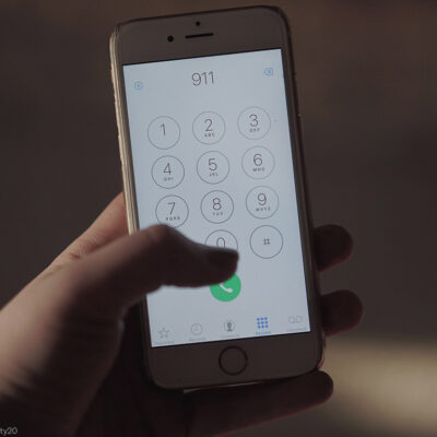 Close up of a hand dialing 911 on a cell phone