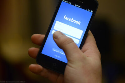 Smart phone in hand with Facebook app