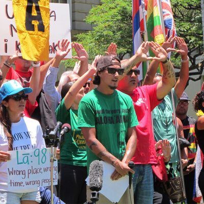 Protesters hold their hands in the shape of a mountain to symbolize protecting Maunakea during a news conference on their efforts to block the construction of the Thirty Meter Telescope