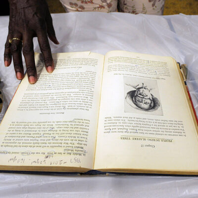 A display on slavery with a whip, book, and shackles