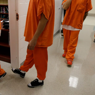 Detainees walk in a hallway at the Northwest Detention Center, a federal immigration facility in Tacoma, Washington.