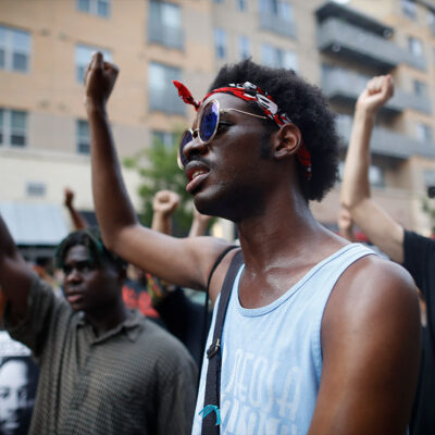 Demonstrators with fists raised in solidarity.