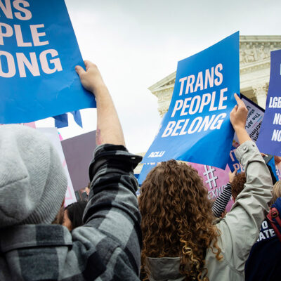 Demonstrators outside the Supreme Court with signs advocating for the rights of LGBTQ people.