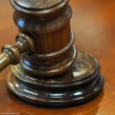 Photo of gavel on judge's bench.