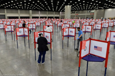 Photo of multiple voting stations set up in the Kentucky Exposition Center for voters to cast their ballot.