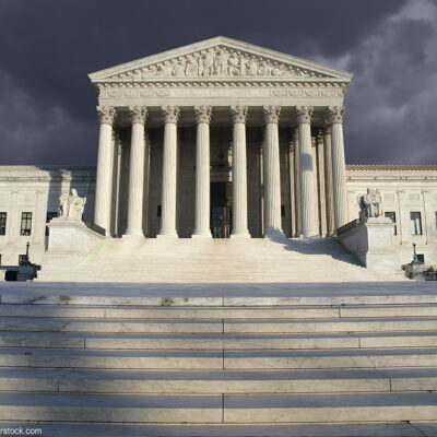 The Supreme Court beneath a cloudy sky.