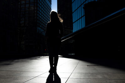 Silhouette of Farah, one of the woman in this blog, standing in front of skyscrapers