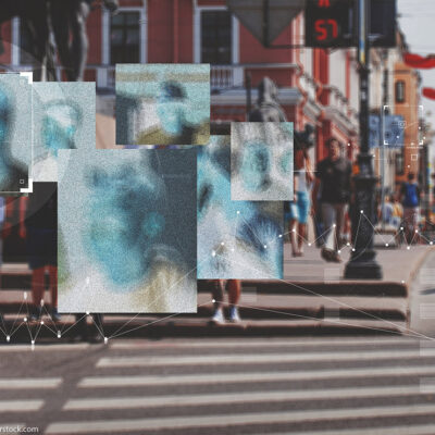 Face recognition boxes placed over people's faces as they cross the street
