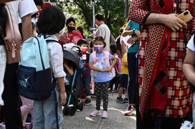 Families line up to drop off their children for in-person learning as New York City Public Schools reopen.