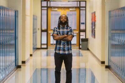Anthony, a teacher profiled in this blog, stands in the middle of his school's hallway